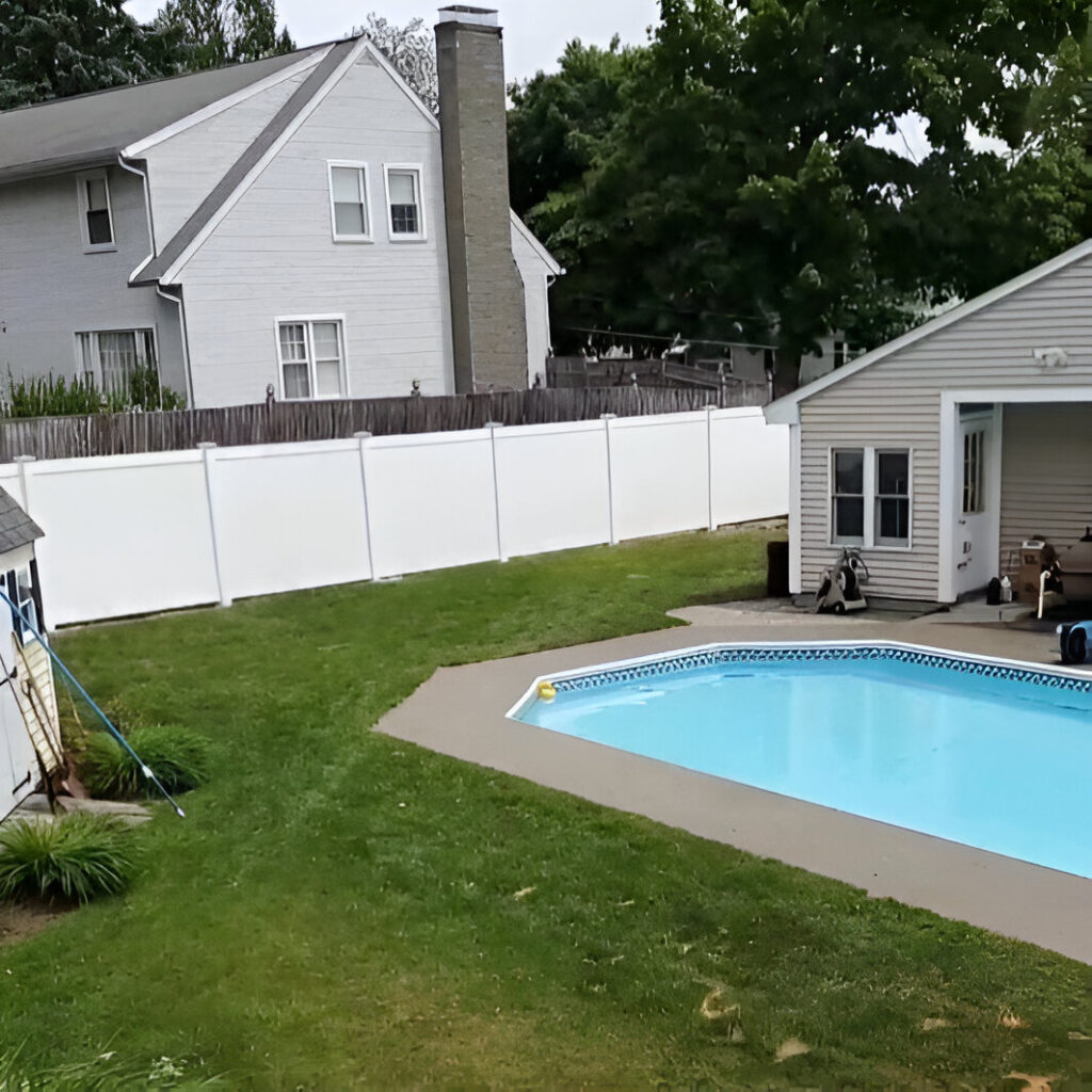 White vinyl privacy fence along property boundary.
