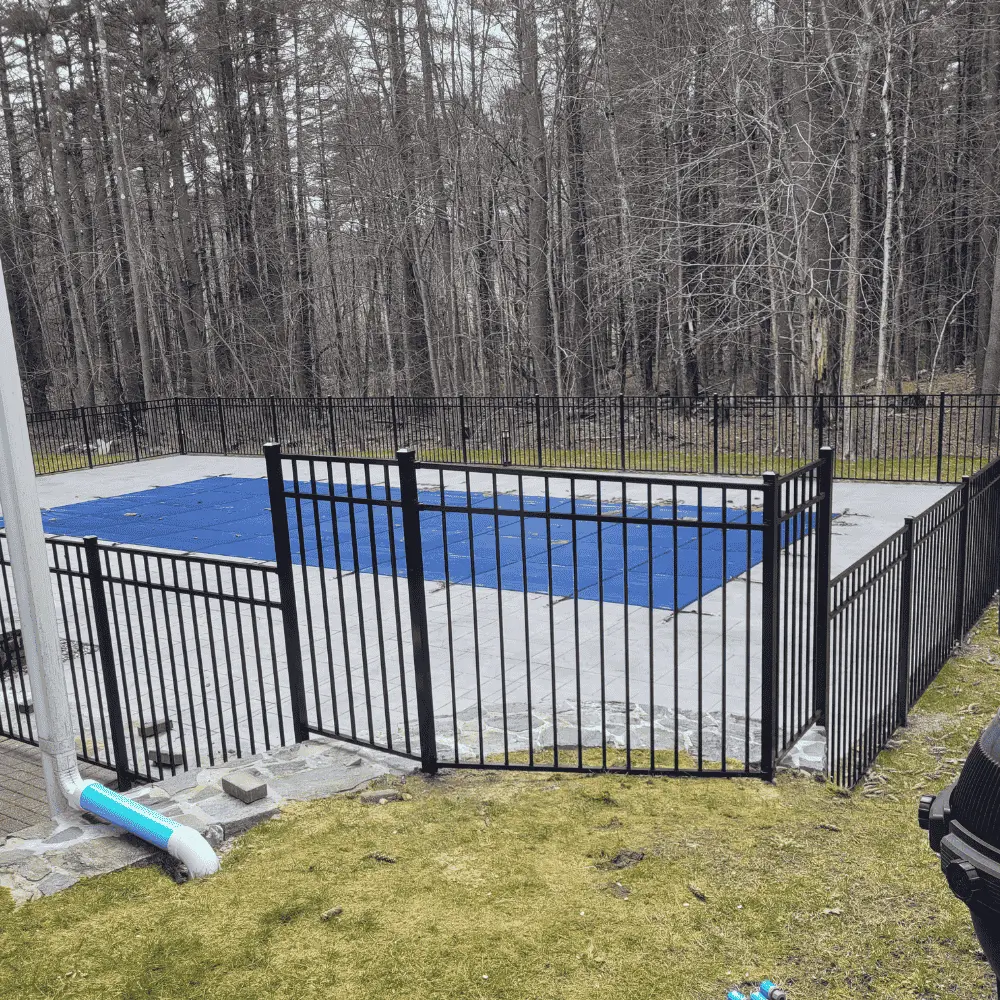 Black aluminum safety fence around swimming pool