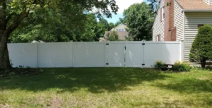 Tall residential privacy fence with double gate