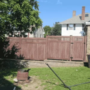 Brown wood privacy fence behind retaining wall